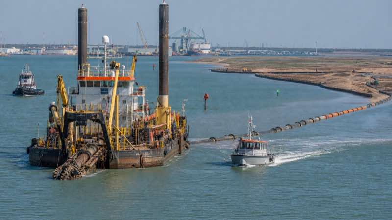 Engineering visualization of Brazos Island Harbor pipeline dredging, with a cutter suction dredge, survey launch and floating pipeline operating in the marked channel