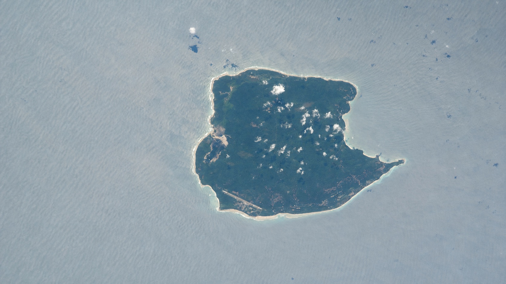 NASA astronaut photograph showing Car Nicobar's complete low-lying coastline and surrounding reef waters