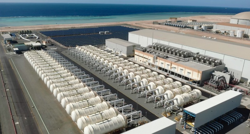 Aerial view of Rabigh 4 IWP process trains, solar array and Red Sea coastline during the 2026 performance-test period