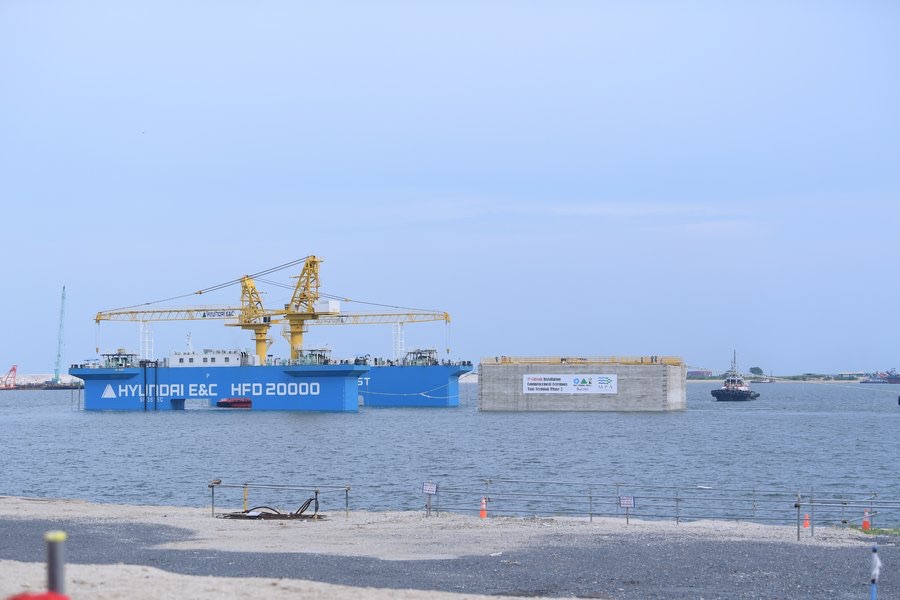 First Tuas Port Phase 2 caisson afloat beside the Hyundai E&C HFD 20000 marine construction vessel and an assisting tug