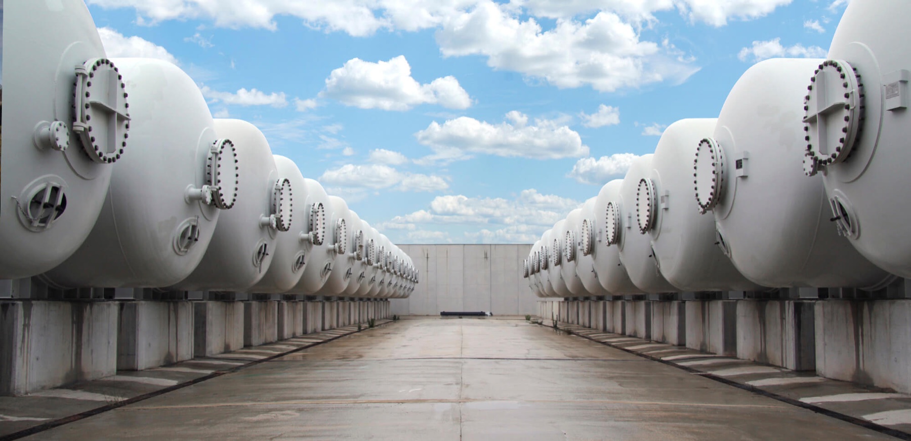 Rows of large white process pressure vessels at a desalination facility in ACCIONA's official desalination visual