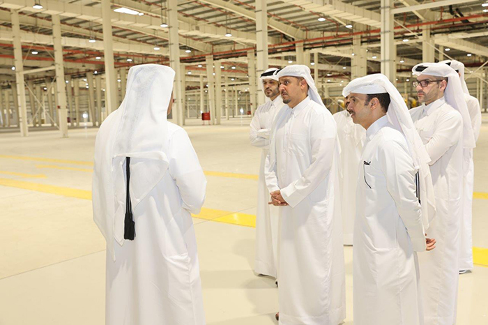 Ashghal officials inspect the interior of a large warehouse building at Hamad Port's food-security facilities project