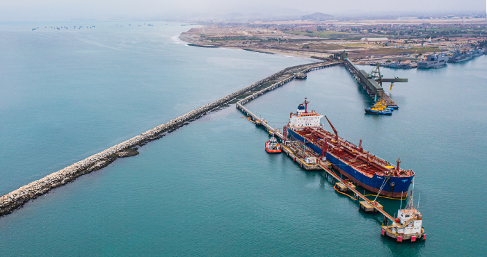 Aerial view of a tanker berth at Callao's mineral-concentrate and hydrocarbon terminal inside the breakwater, with port infrastructure and cranes beyond
