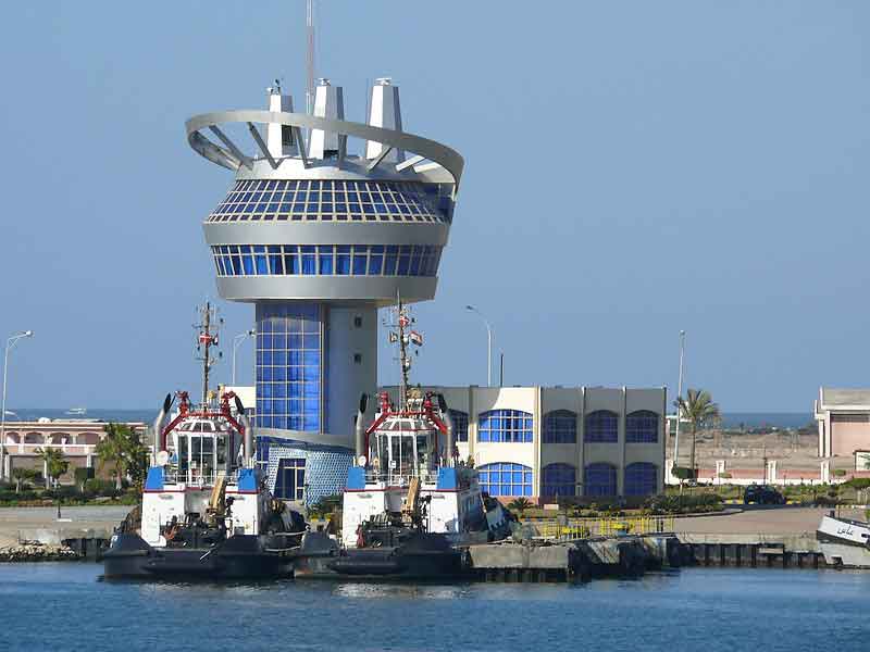 Damietta Port harbour control tower and two harbour tugs moored inside the port