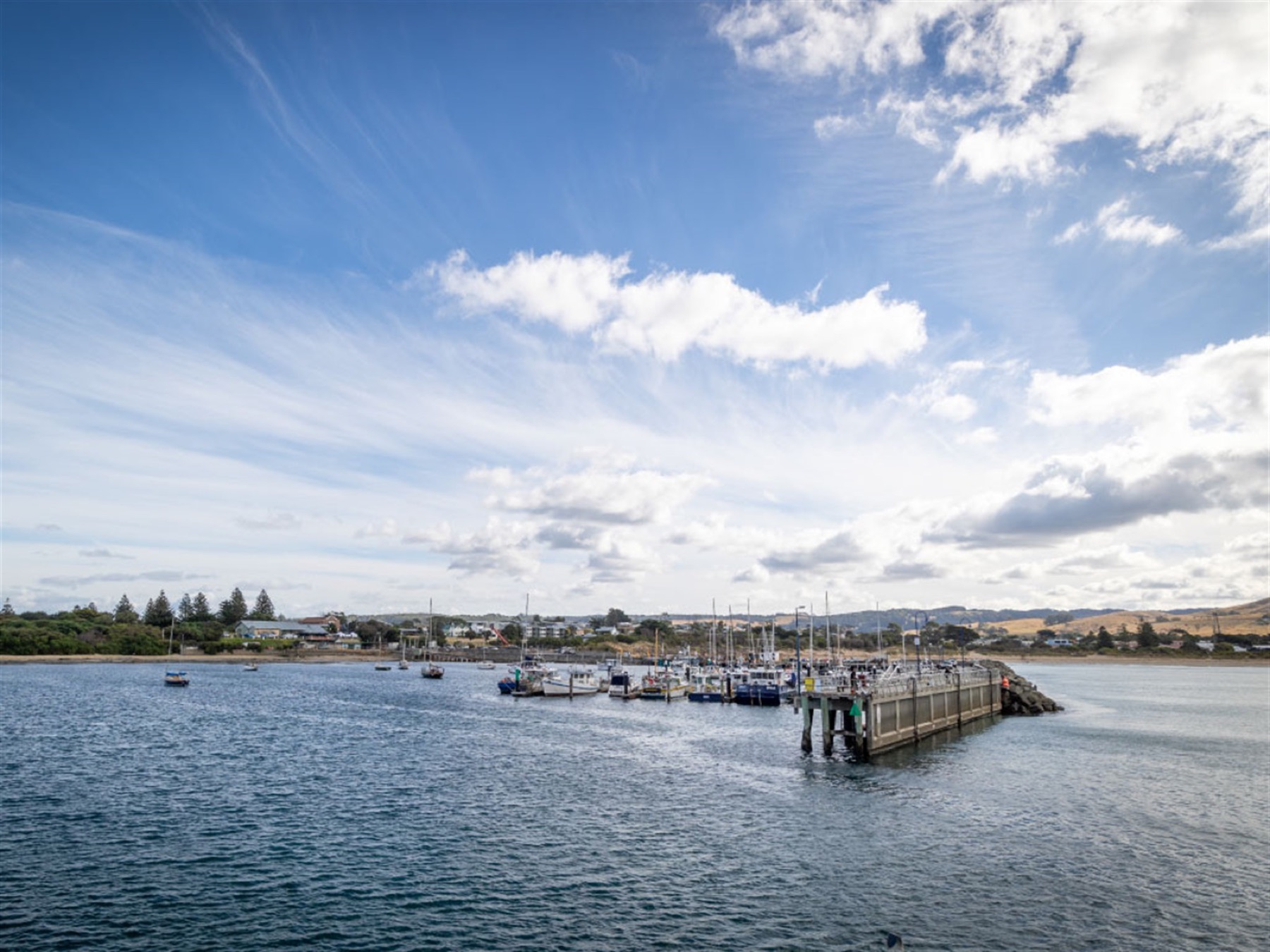 Port of Apollo Bay harbour with its commercial fishing fleet, marina berths, wharf and breakwater