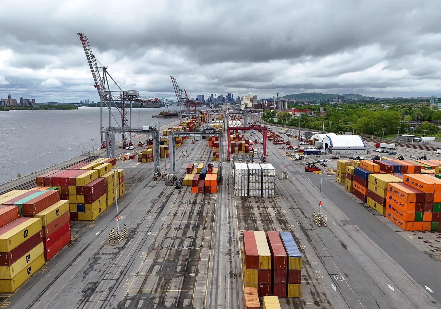 Aerial view of active Port of Montreal container operations beside the St. Lawrence River in May 2025