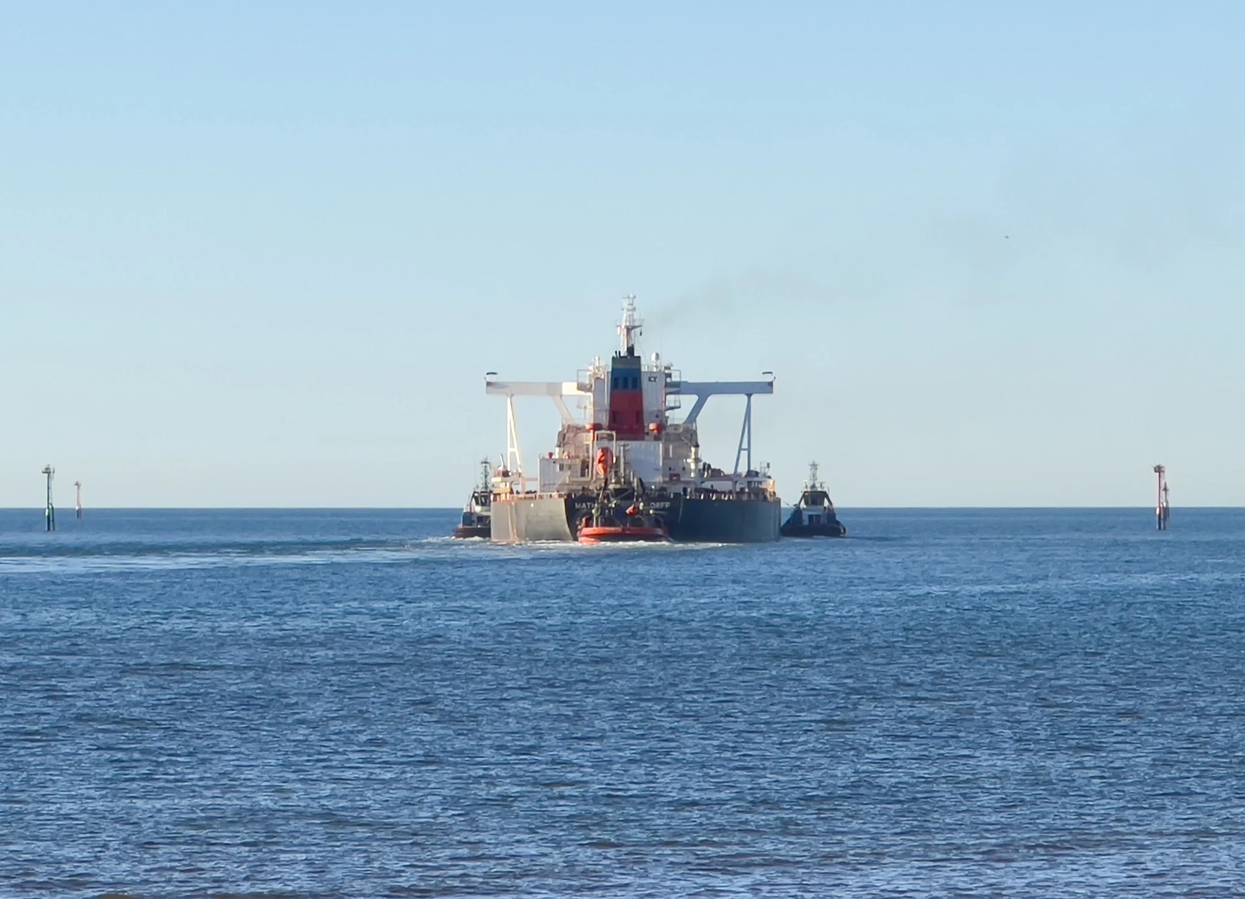 Bulk carrier transiting the Port Hedland channel with tug assistance in 2023