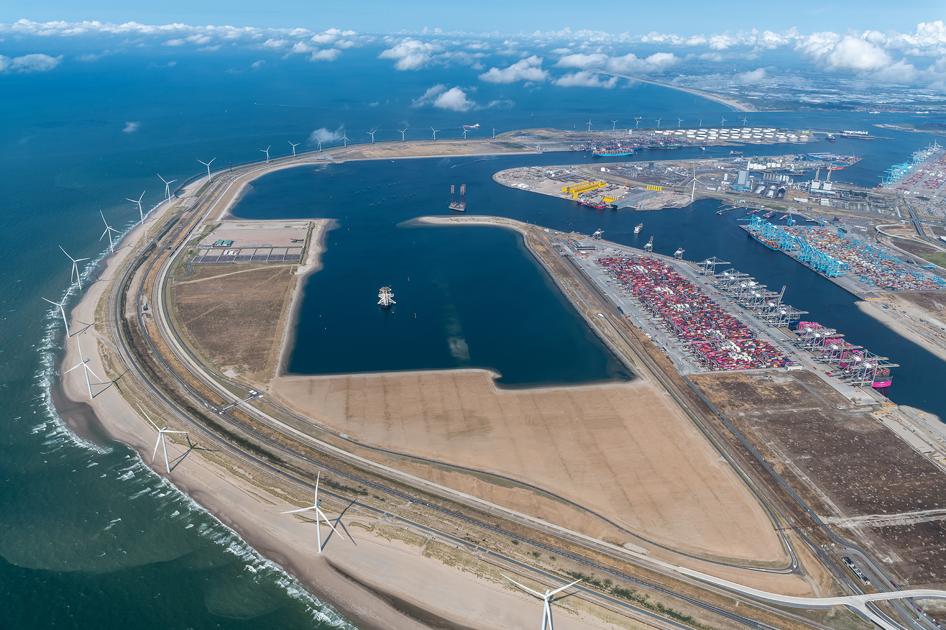 Aerial view across the port basins, waterways, quay terminals and sea defences of Maasvlakte 2 at Rotterdam