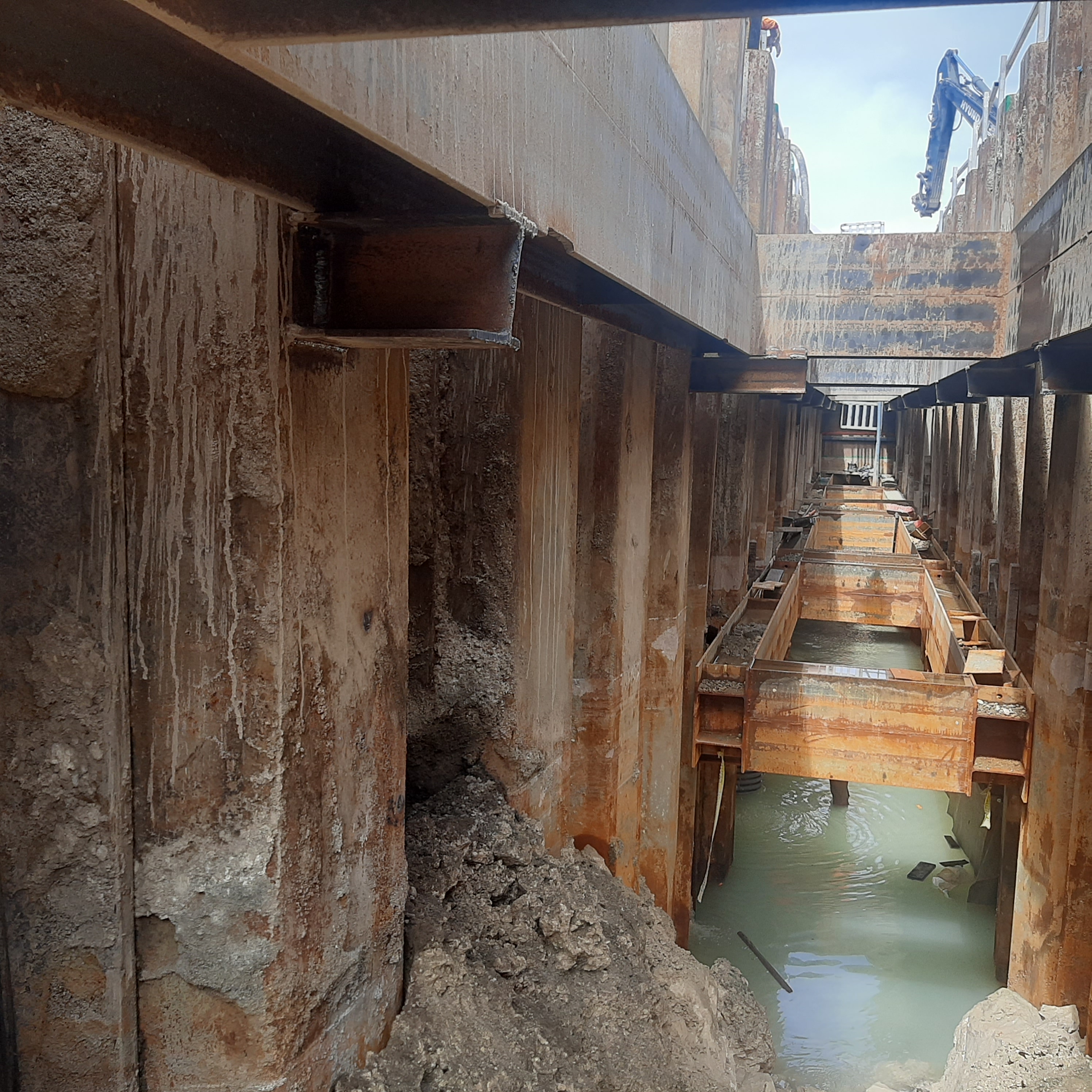 Deep sheet-piled trench with temporary steel bracing and groundwater on Solomon Water's Fisheries-to-Ranadi sewer works in Honiara