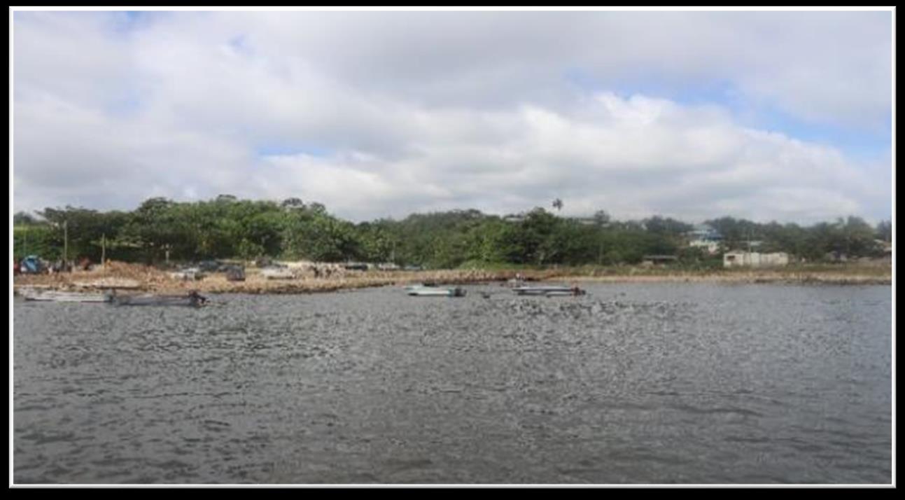 Nafanua Port harbour looking west across the water toward small boats and the shoreline on 'Eua