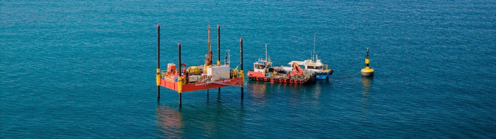 Jack-up geotechnical investigation barge with support vessels working in Cockburn Sound for the proposed Westport port and shipping-channel design