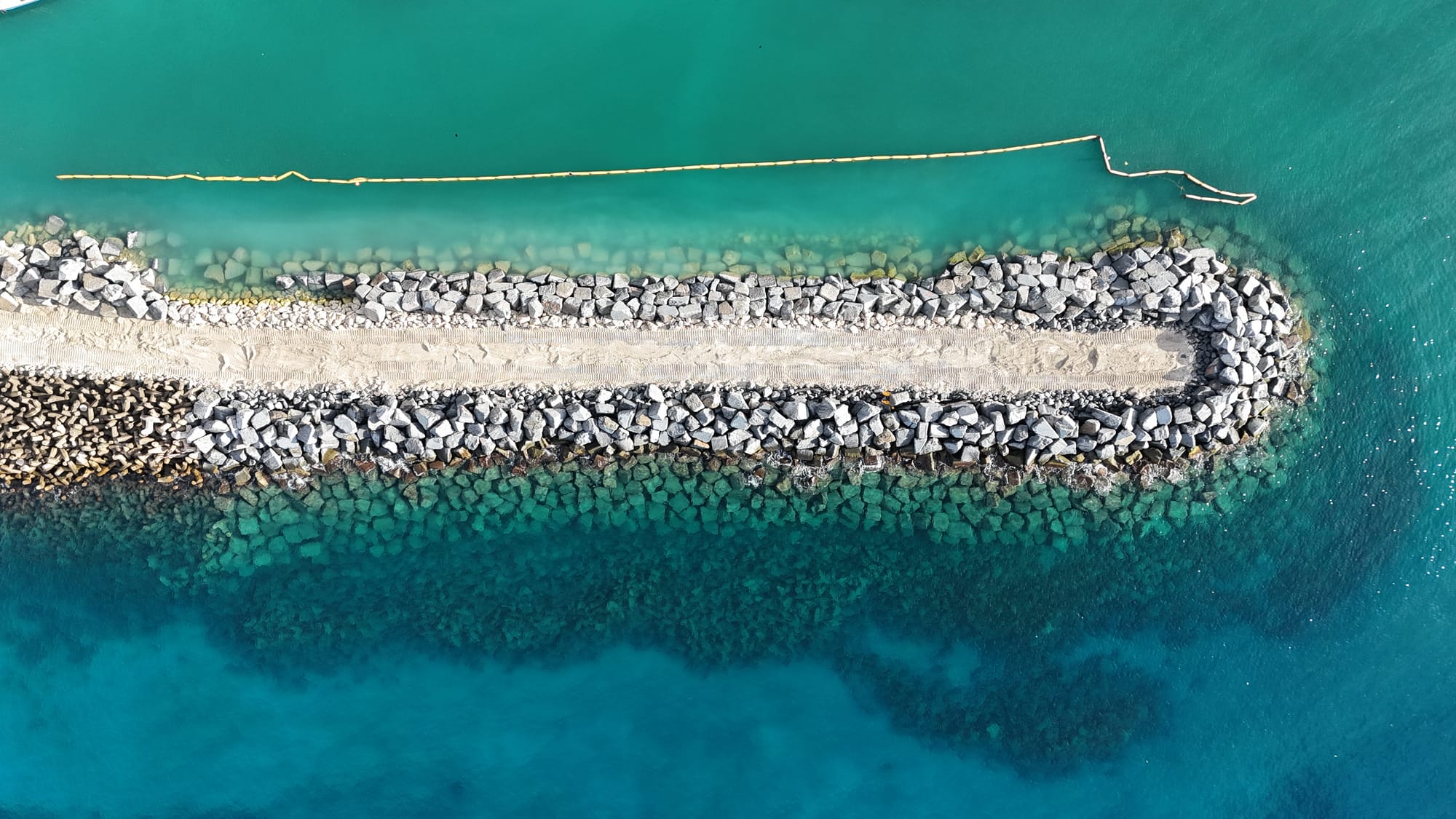 Dated overhead view of the Bridgetown Fisheries Complex breakwater showing new armour stone along the trunk and head on 15 November 2025